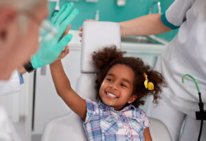 little girl giving orthodontist high five