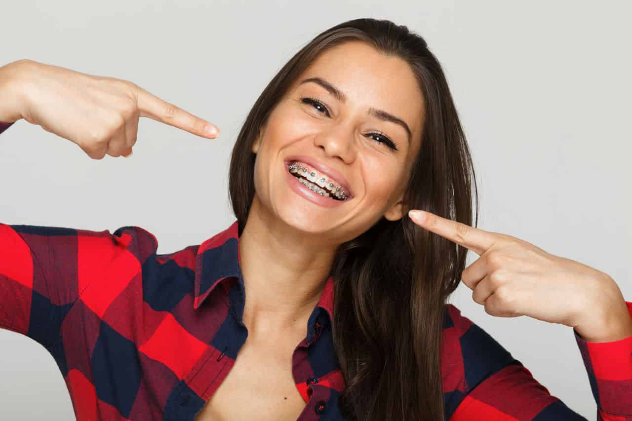 Face of a young woman with braces on her teeth Face of a young woman with braces on her teeth